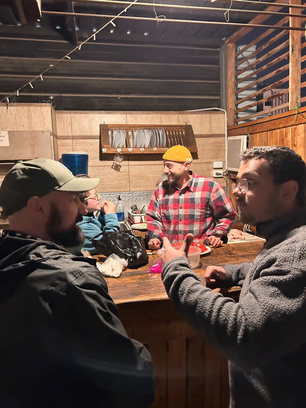 Usuf connecting with travelers at a hostel